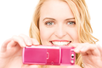 Image showing happy woman using phone camera