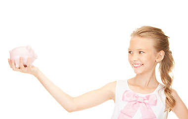 Image showing lovely teenage girl with piggy bank