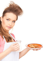 Image showing housewife with milk and cookies