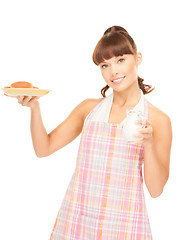 Image showing housewife with milk and cookies