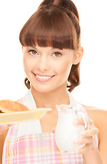 Image showing housewife with milk and cookies