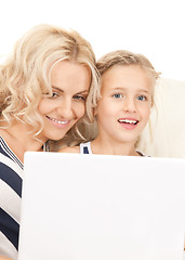 Image showing happy mother and child with laptop computer