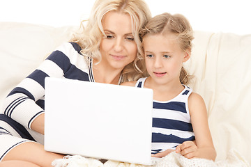 Image showing happy mother and child with laptop computer