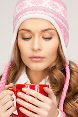 Image showing beautiful woman with red mug