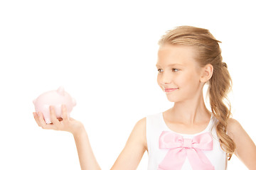 Image showing lovely teenage girl with piggy bank