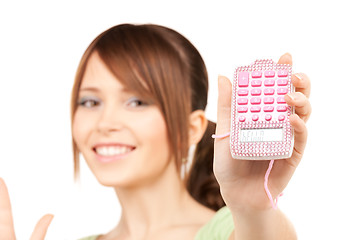 Image showing lovely teenage girl with calculator