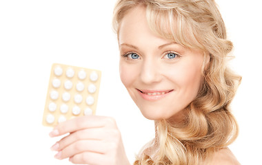 Image showing young woman with pills