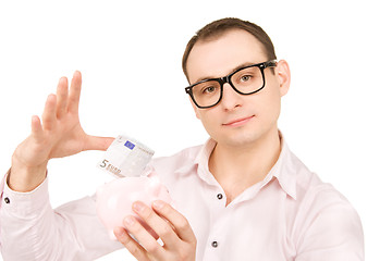 Image showing businessman with piggy bank and money