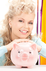 Image showing lovely woman with piggy bank