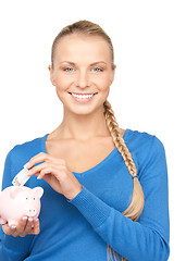 Image showing lovely woman with piggy bank and money