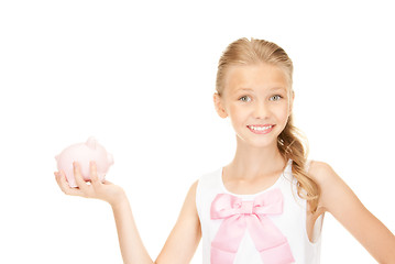 Image showing lovely teenage girl with piggy bank