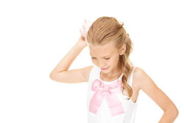 Image showing lovely teenage girl with piggy bank