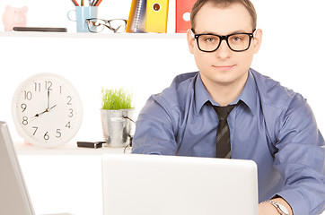 Image showing businessman with laptop computer in office