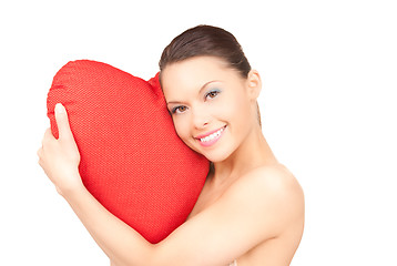 Image showing woman with red heart-shaped pillow over white 