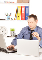 Image showing businessman with laptop computer in office