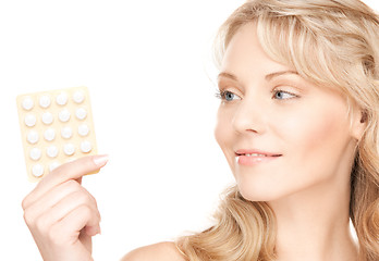 Image showing young woman with pills