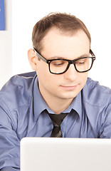 Image showing businessman with laptop computer in office