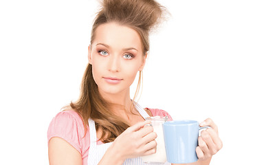 Image showing housewife with milk and mug