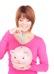 Image showing lovely woman with piggy bank and money