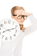 Image showing girl holding big clock