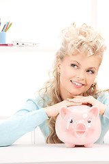 Image showing lovely woman with piggy bank