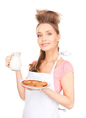 Image showing housewife with milk and cookies