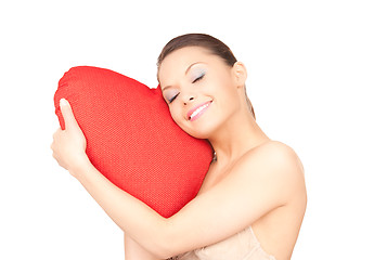 Image showing woman with red heart-shaped pillow over white 