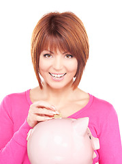 Image showing lovely woman with piggy bank and money