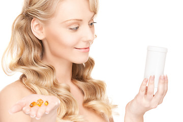 Image showing young woman with pills