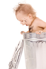 Image showing baby in trash can