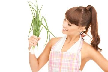 Image showing beautiful housewife with spring onions over white