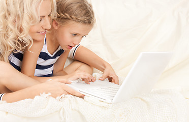 Image showing happy mother and child with laptop computer