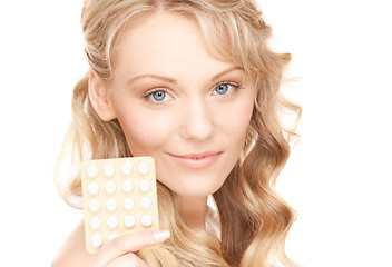 Image showing young woman with pills