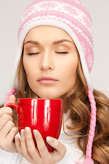 Image showing beautiful woman with red mug