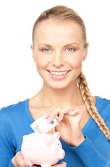 Image showing lovely woman with piggy bank and money