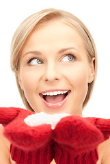 Image showing beautiful woman in red mittens with snow