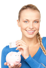 Image showing lovely woman with piggy bank and money