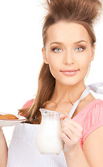 Image showing housewife with milk and cookies