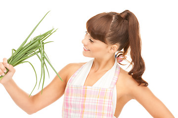 Image showing beautiful housewife with spring onions over white