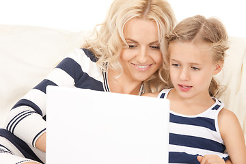 Image showing happy mother and child with laptop computer