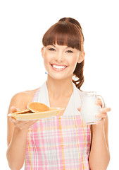 Image showing housewife with milk and cookies