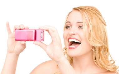 Image showing happy woman using phone camera