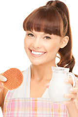 Image showing housewife with milk and cookies