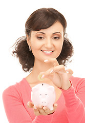 Image showing lovely woman with piggy bank and money