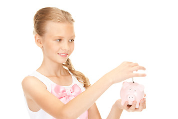 Image showing lovely teenage girl with piggy bank and money