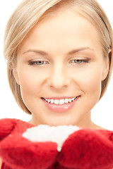 Image showing beautiful woman in red mittens with snow