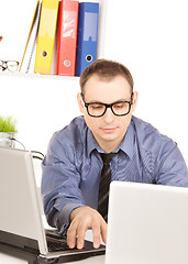 Image showing businessman with laptop computer in office