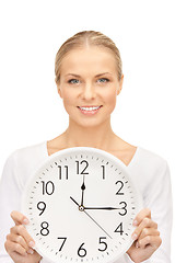 Image showing woman holding big clock