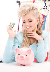 Image showing lovely woman with piggy bank and money