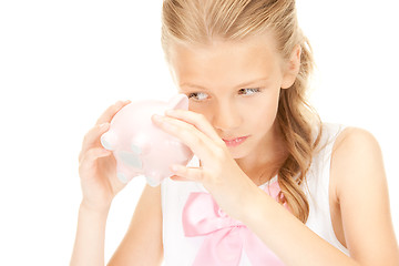 Image showing lovely teenage girl with piggy bank